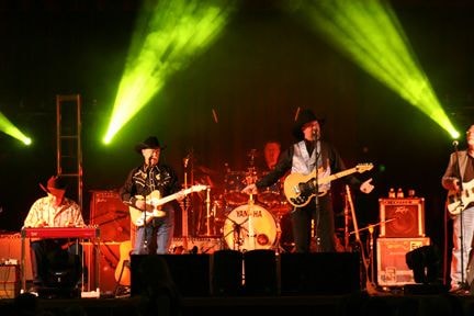 Live band performing on stage with dramatic lighting